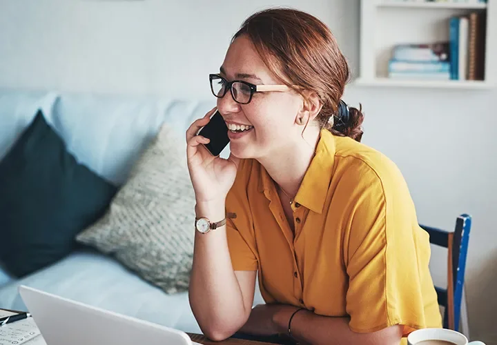 Woman talking on the phone with a customer service representative