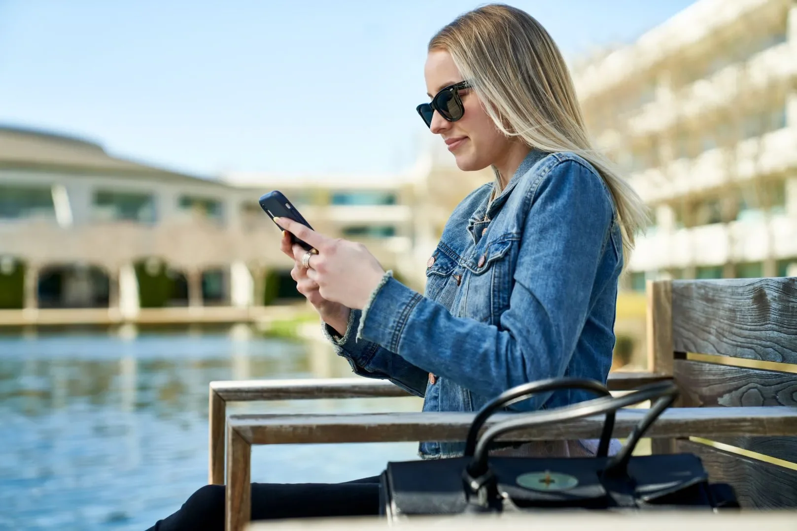 Woman on her phone at a lake