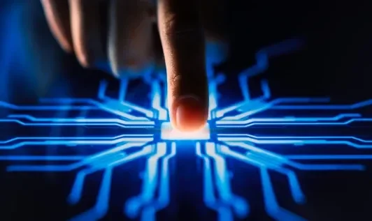 A finger touching a motherboard